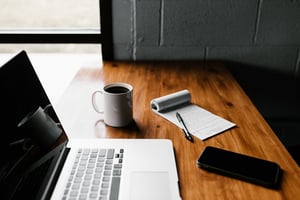 laptop and phone on work table